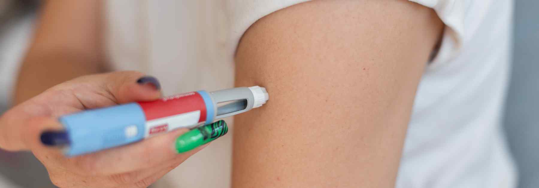 Weight loss pen being injected via the upper arm