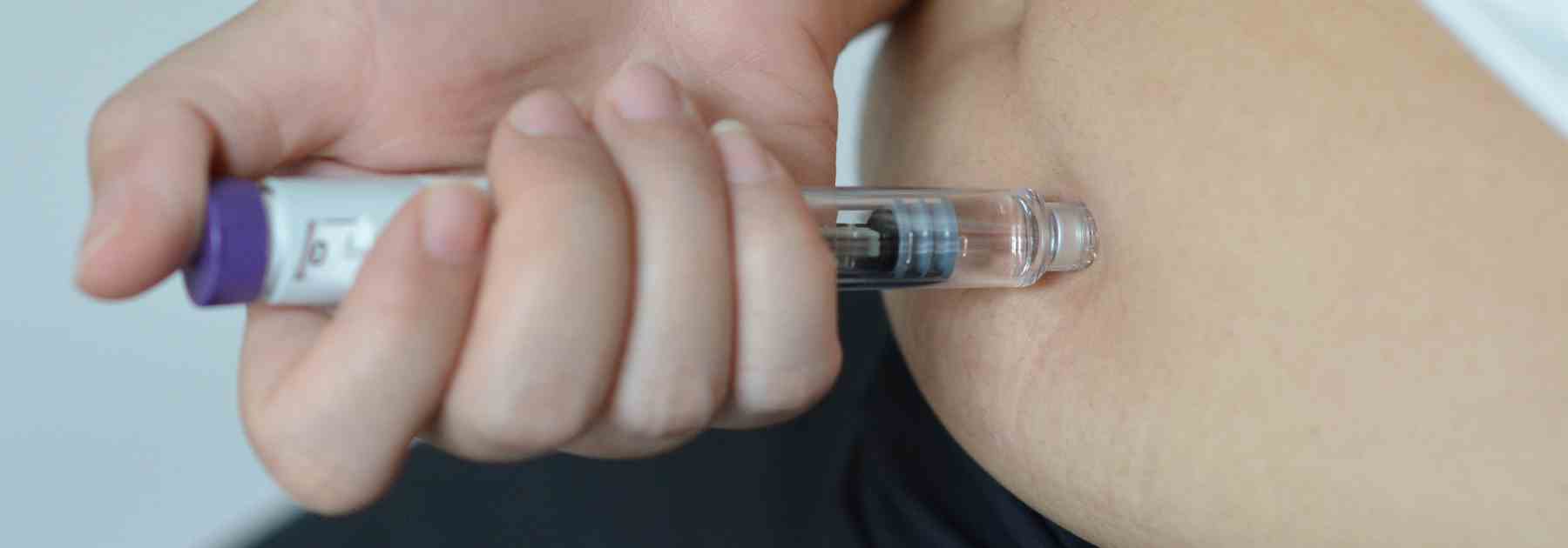 Close up weight loss injection into stomach
